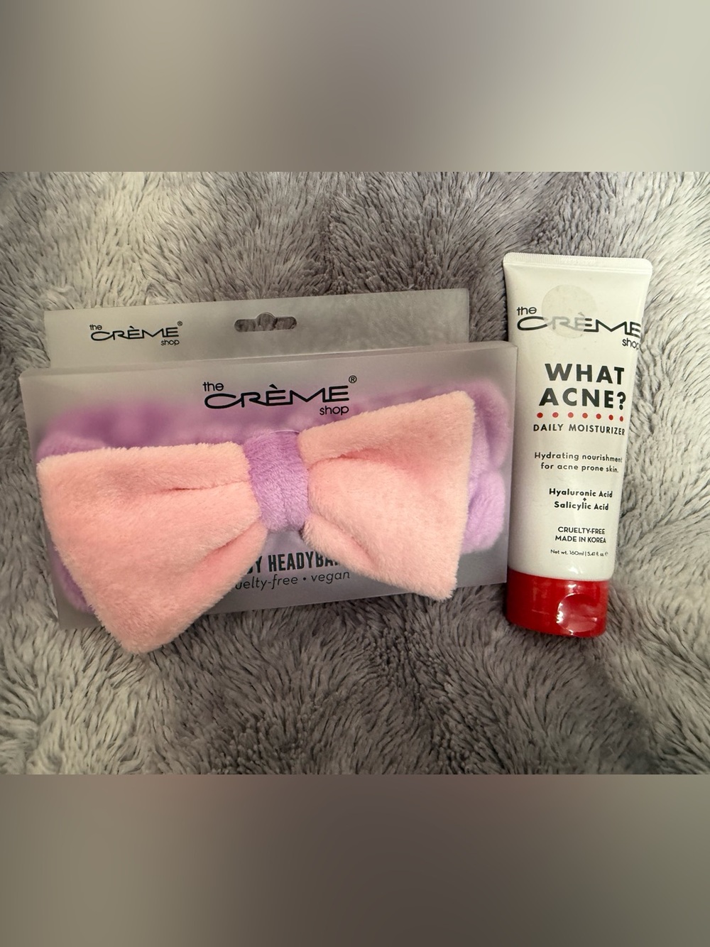 Crème Shop Pink & Lavender Plush Bow Headband + WHAT ACNE Daily Moisturizer Set